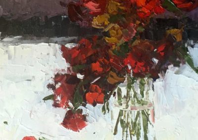An original oil painting of a bouquet of vibrant red flowers with fallen petals.
